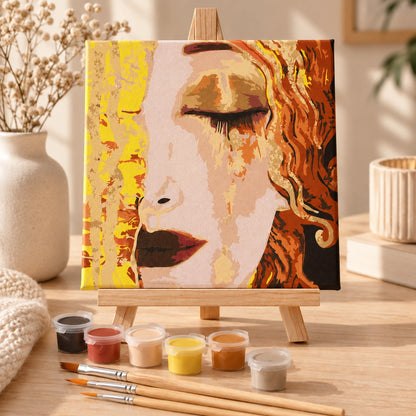 Golden Tears framed paint by numbers kit displayed on a wooden tabletop easel