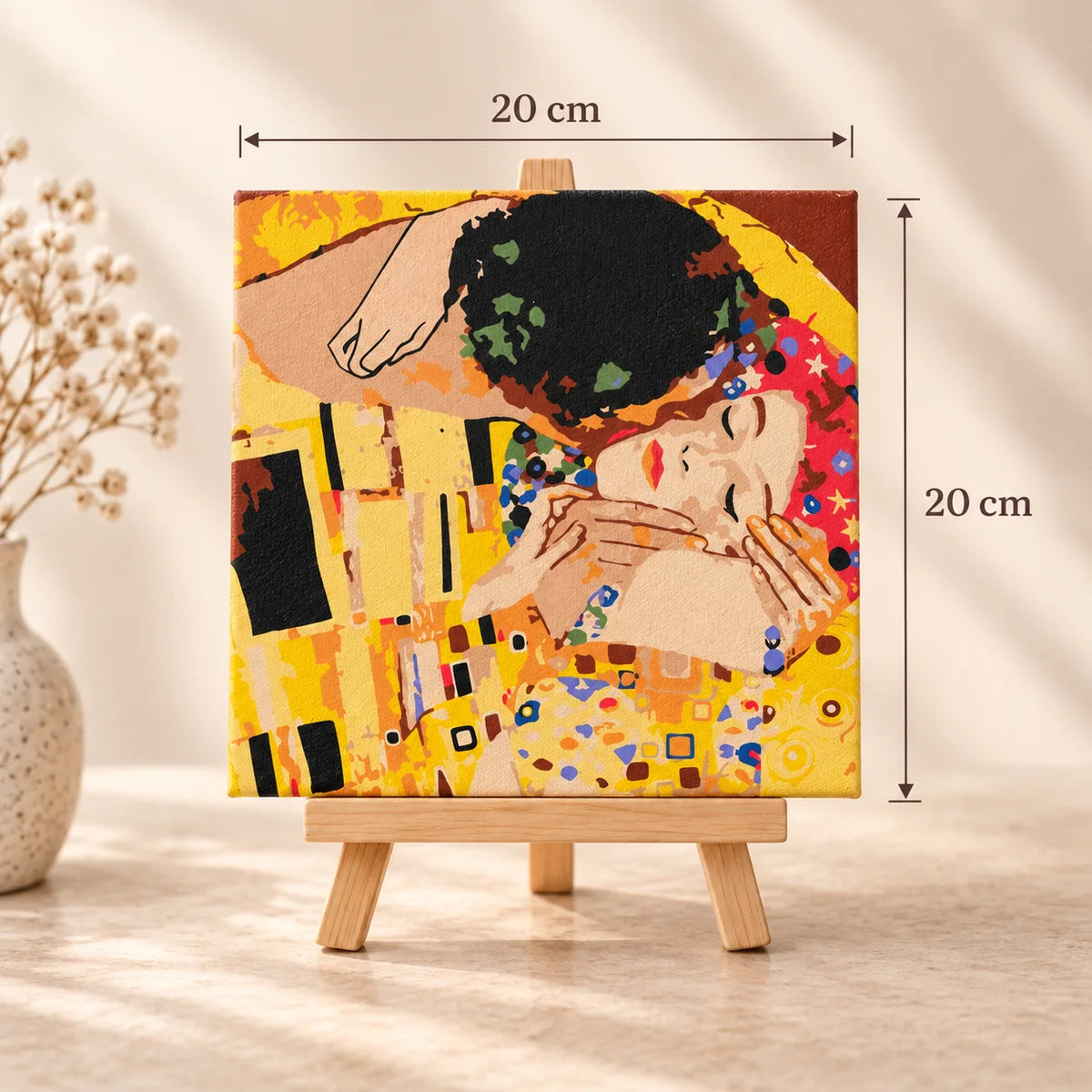 The Kiss 20x20 cm square mini masterpiece canvas shown on a wooden easel