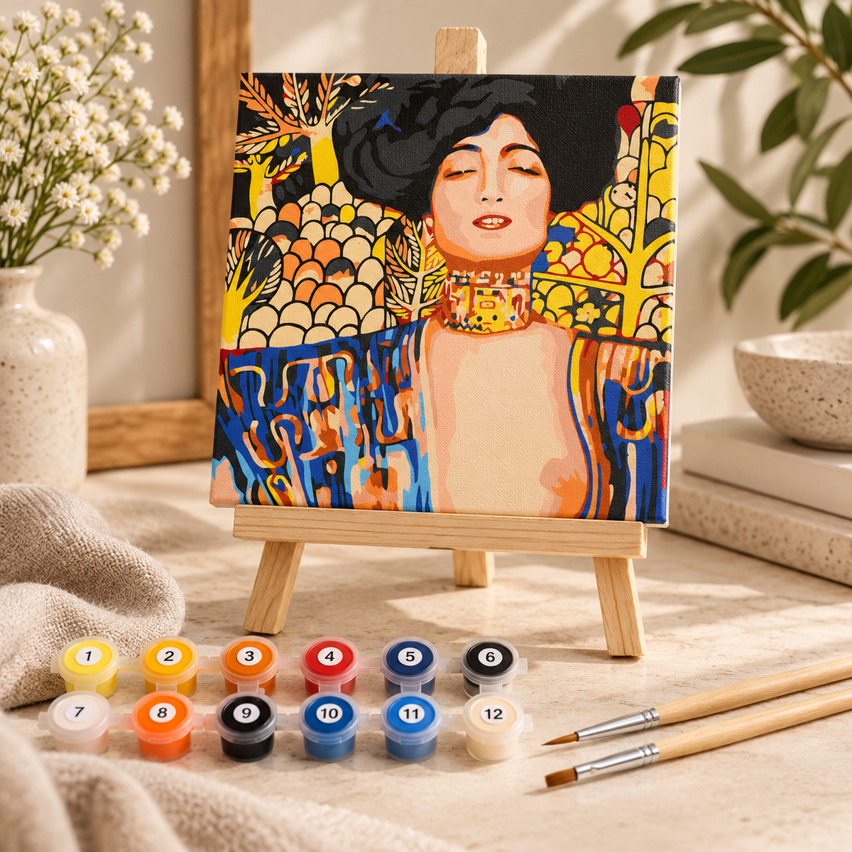 Finished Gustav Klimt Judith paint by numbers artwork displayed on a small wooden tabletop easel