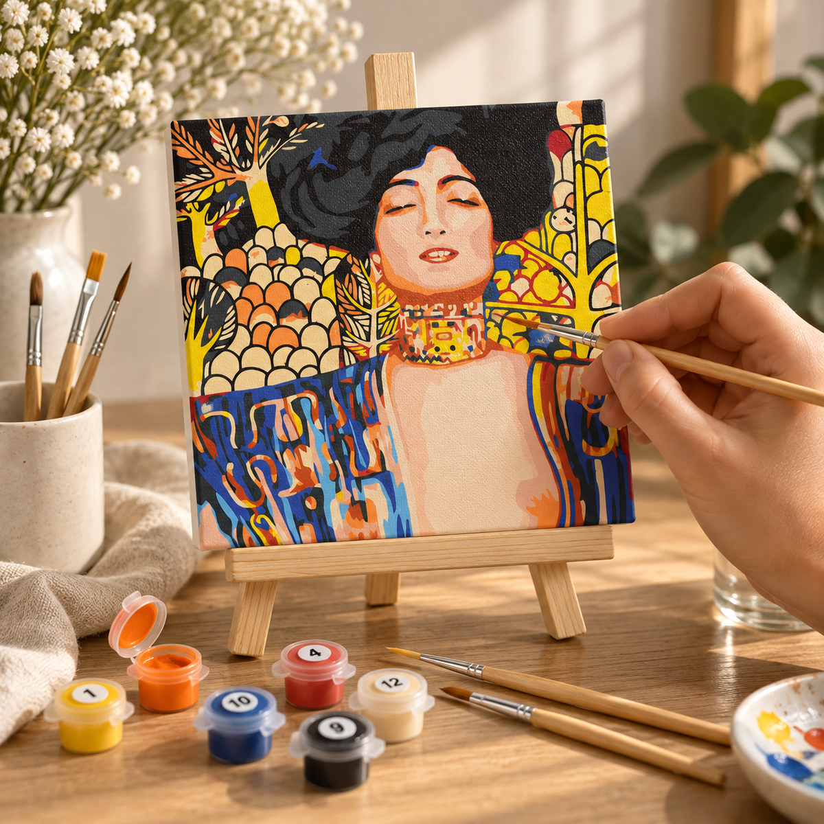 Gustav Klimt Judith paint by numbers in progress on a 20 x 20 cm canvas with wooden brush and numbered paints