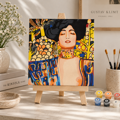 Gustav Klimt Judith paint by numbers artwork displayed on a tabletop easel in a warm neutral interior