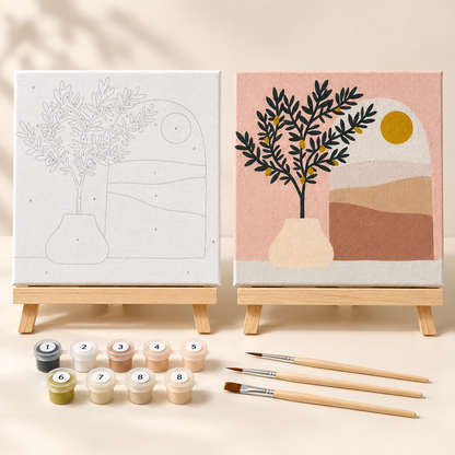 Olive Tree mini paint by numbers kit shown beside the completed 20 x 20 cm framed artwork on a wooden easel