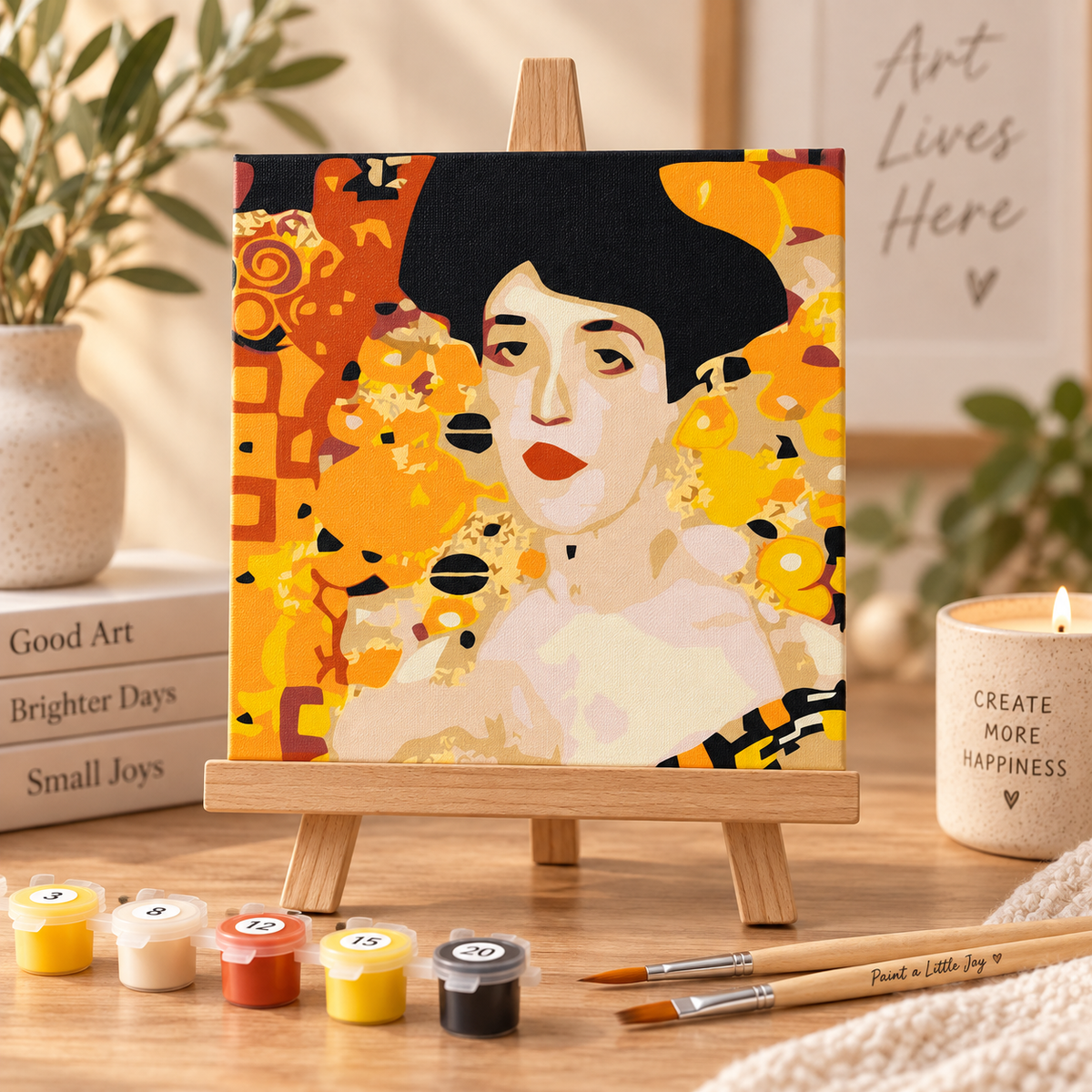 Finished Woman in Gold paint by numbers artwork displayed on a small wooden tabletop easel